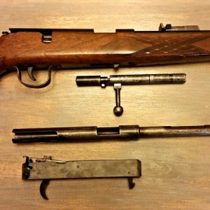 The Wischo rifle sporting the Voere sight, pictured next to the Voere bolt, action/barrel and trigger group.