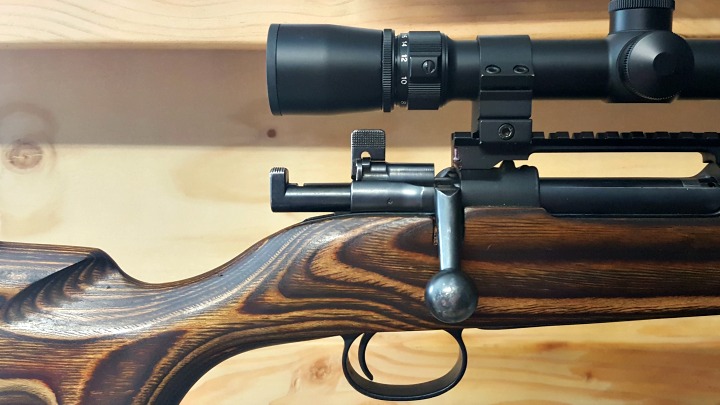 Lift the safety lever into the upright position and remove the bolt without lowering the safety. You may need to remove your scope if the safety won't clear it.