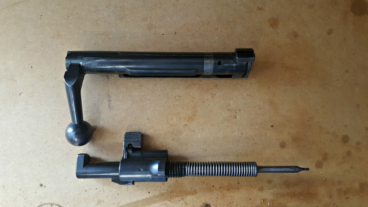 The firing pin separated from the bolt body. Again, note the spring is locked back - if you don't do the next step carefully, the spring, cocking piece, and firing pin could separate with a fair amount of speed and force.
